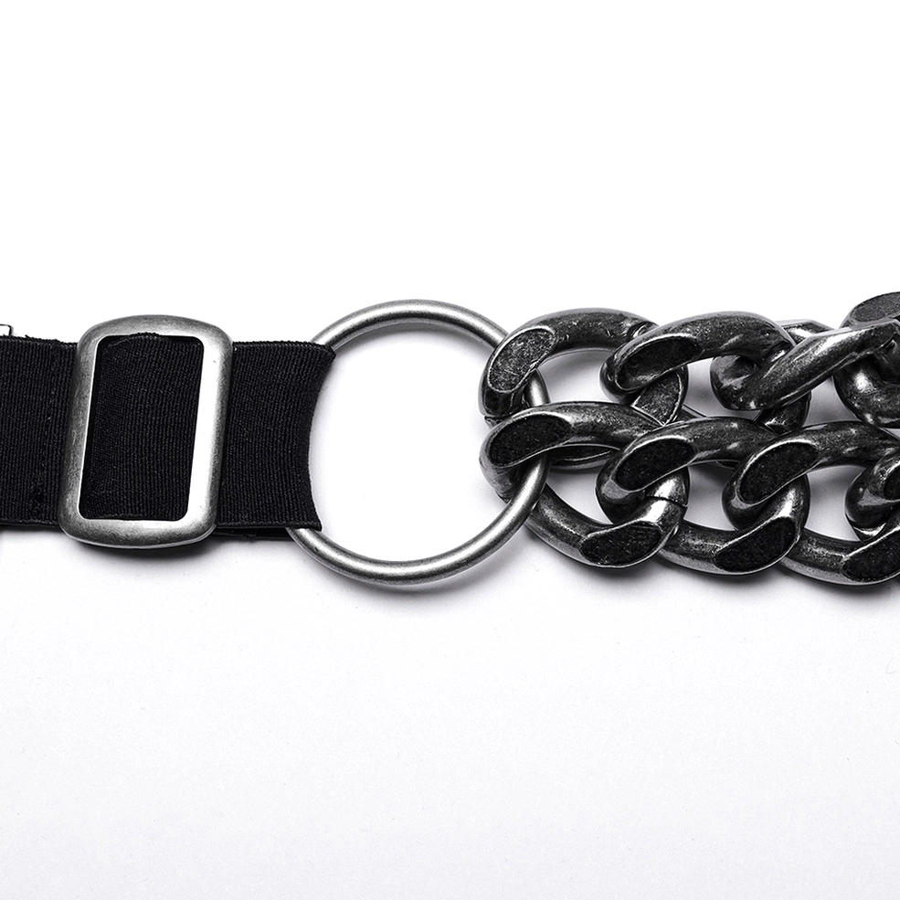 Detailed macro shot of chain harness connection point showing metal O-ring, webbing strap and gunmetal finish