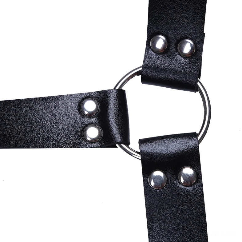 Close-up detail of gothic harness metal D-ring hardware and round silver rivets on black faux leather strap