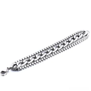 Double-layer metal chain bracelet flat lay top view with lobster clasp closure detail, stainless steel gothic jewelry on white background