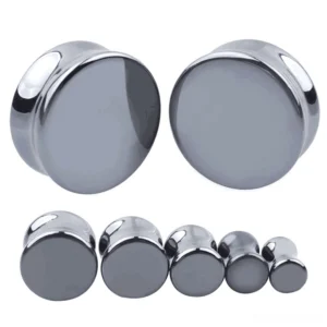 Dark polished hematite stone ear gauges in multiple sizes displayed on studio white background, showing front and side perspective of double-flared gothic ear plugs