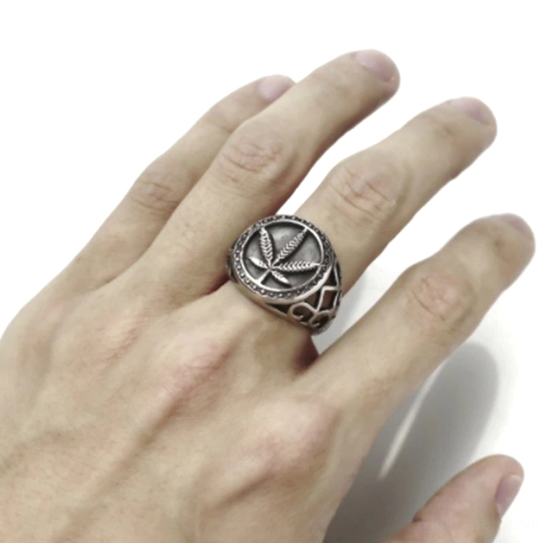 Worn hemp leaf biker ring on male hand middle finger showing authentic vintage character