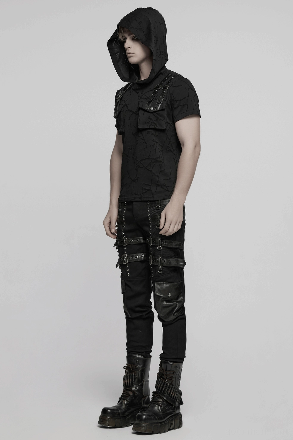 Full rear profile of industrial goth metal studded pants with leather back pockets and hardware fixtures