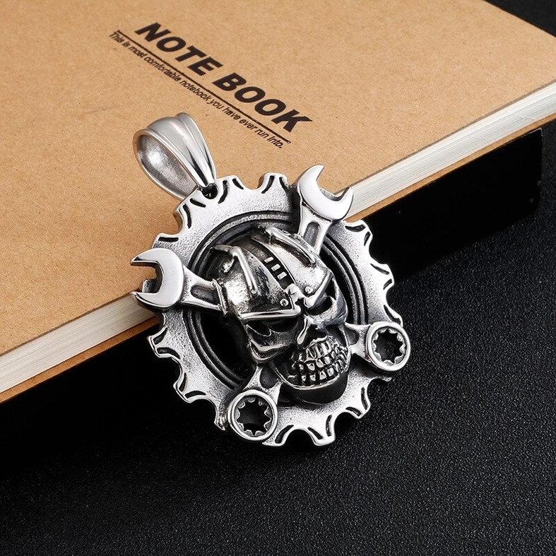 Industrial punk style mechanical skull pendant on black background with vintage silver metal texture
