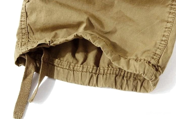 Khaki cargo capri shorts close-up detail - cotton canvas fabric and drawstring hem adjustment