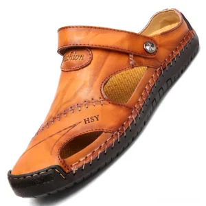 Khaki tan leather men's gothic moccasin sandals with adjustable strap and embroidered branding, oblique angle