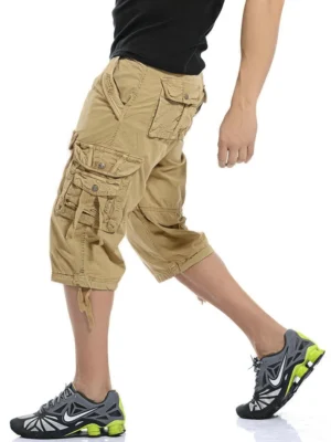 Khaki gothic cargo shorts side view walking pose - drawstring hem and multi-pocket tactical design