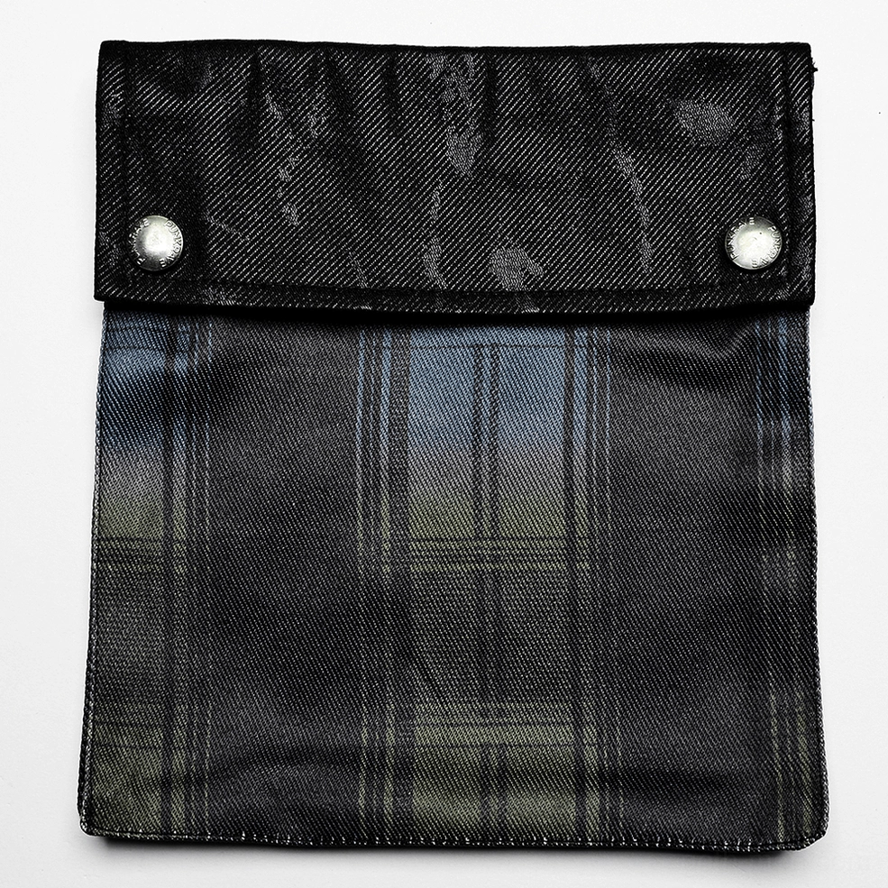 Kilt side pocket close-up flap design metal snap buttons faux leather trim detail