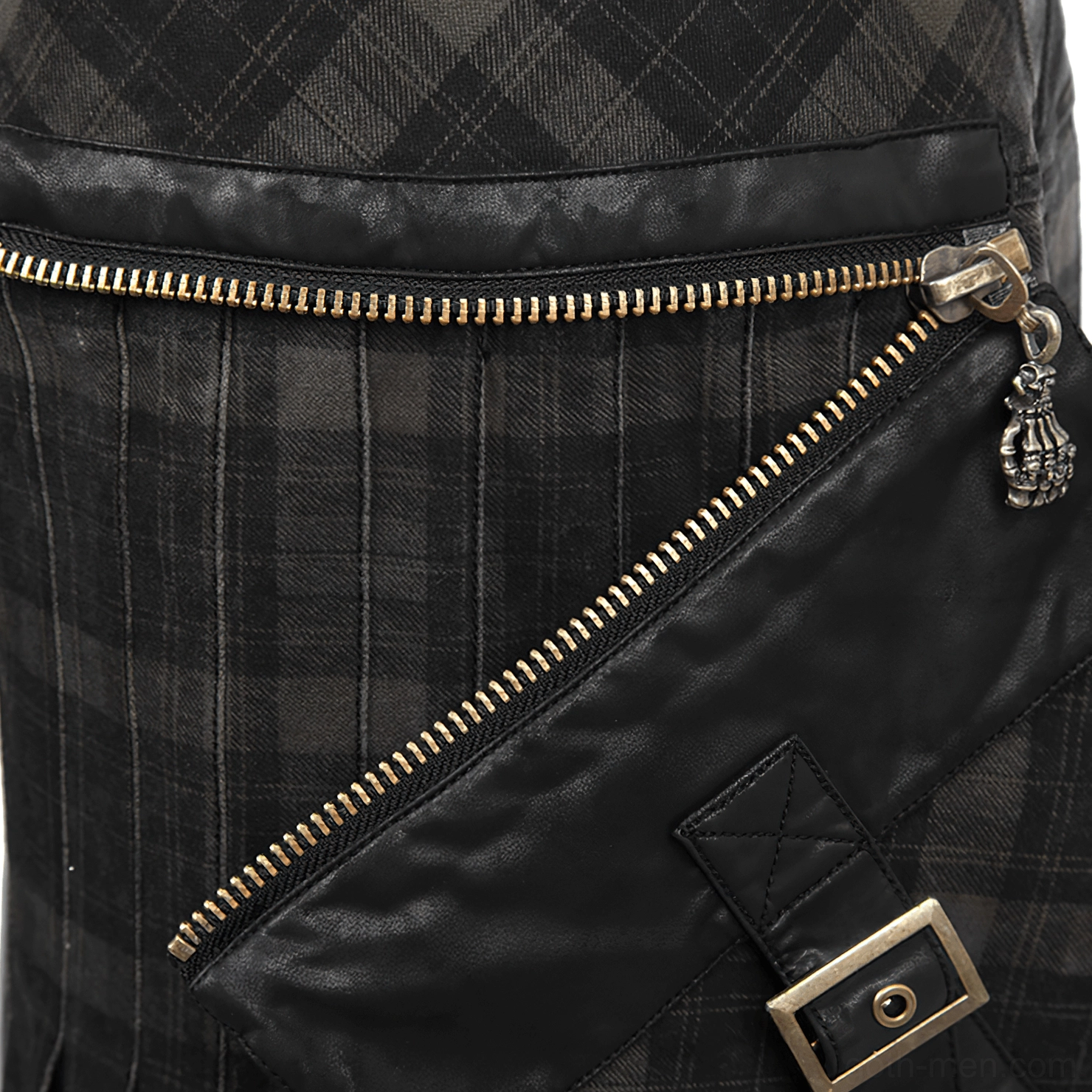 Top-down close-up of kilt zipper trim showing brass-toned hardware and leather pocket flap detail