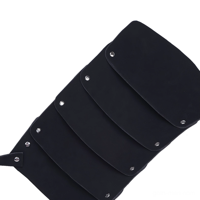 Stacked black faux leather armor plates with silver rivet fasteners showing layered construction of gothic harness