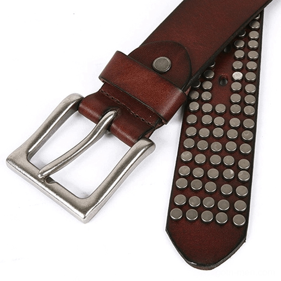 Brown leather belt tip showing dense metal rivets and silver buckle attachment point