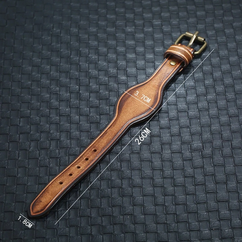 Flat lay overhead view of brown leather cuff bracelet showing complete size measurement reference on black background