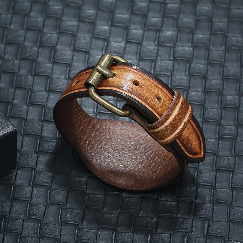 Leather cuff bracelet front view featuring adjustable buckle mechanism and rounded wide band edge design