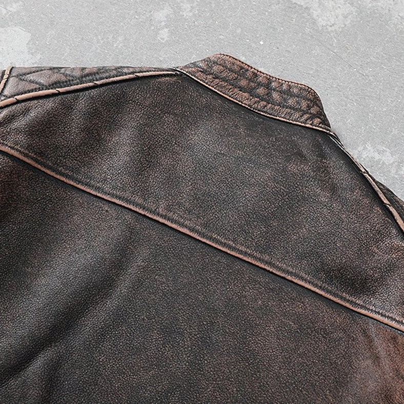 Rear close-up of genuine leather motorcycle jacket back yoke with reinforced stitching and stand collar detail