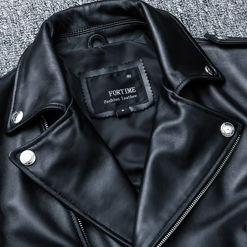 Detailed view of black leather jacket collar with snap fasteners and notched lapel design