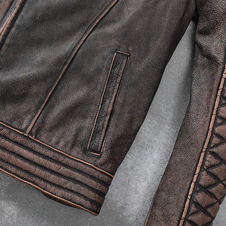 Premium brown genuine leather biker jacket pocket and zipper hardware close-up with industrial metal accents