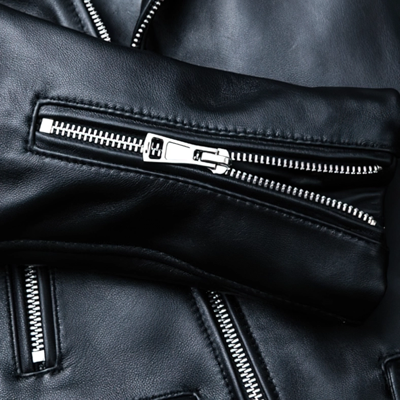 Metal zipper pocket detail on black leather biker jacket showing dual silver slider mechanism