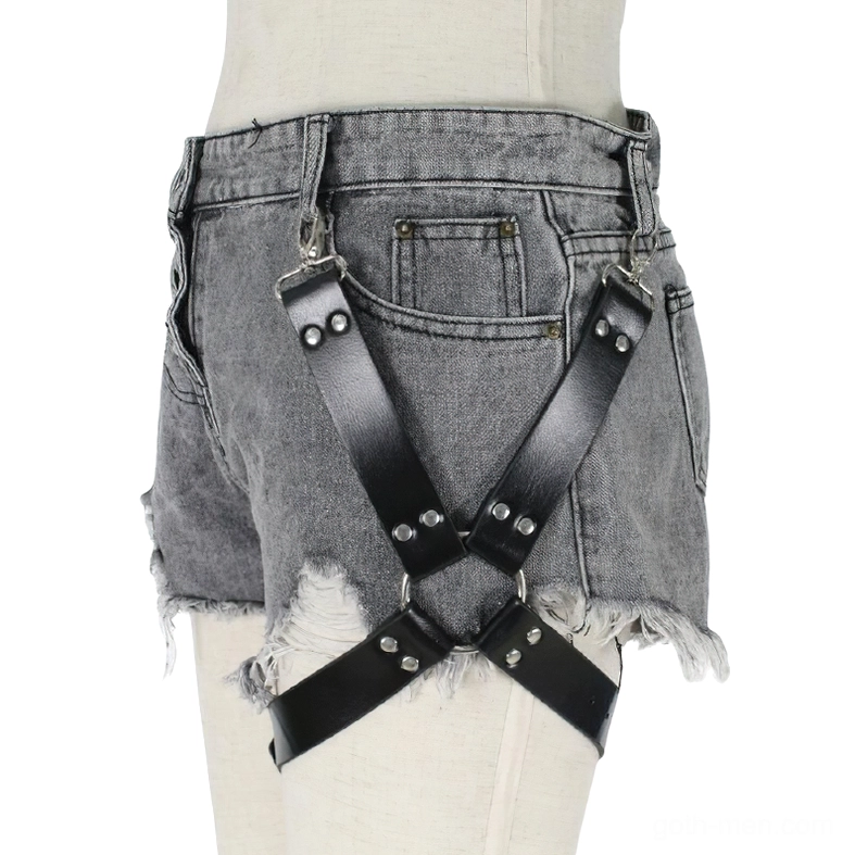 Gothic leg harness with black leather straps and metal buckle worn over frayed grey denim shorts, front view