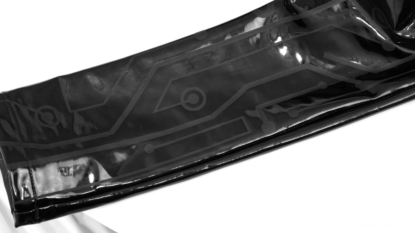 Black patent leather pants leg hem and tapered opening detail close-up view