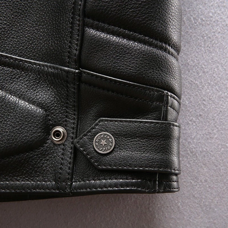 Detail angle showing multiple metal zippers and studs on black leather motorcycle vest