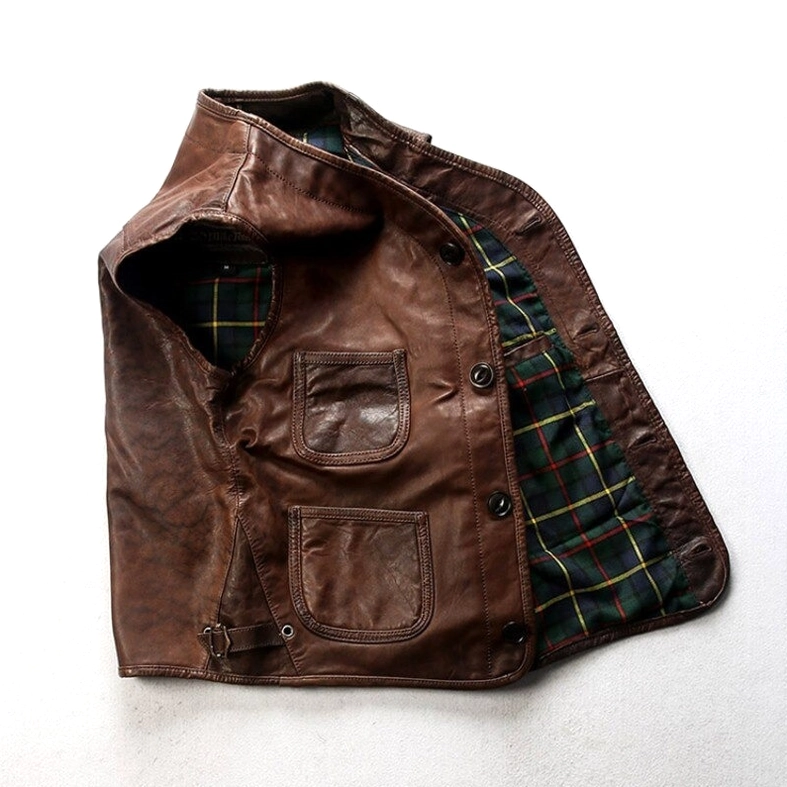 Open side view of leather biker waistcoat showing tartan green flannel lining and side adjustment buckles for custom fit