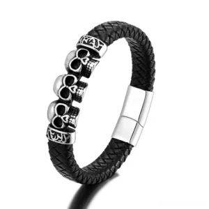Black braided leather bracelet featuring linked stainless steel skull emblem with magnetic snap closure