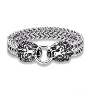 Dual lion head stainless steel gothic punk bracelet with woven curb chain, silver finish, top-down flat lay view