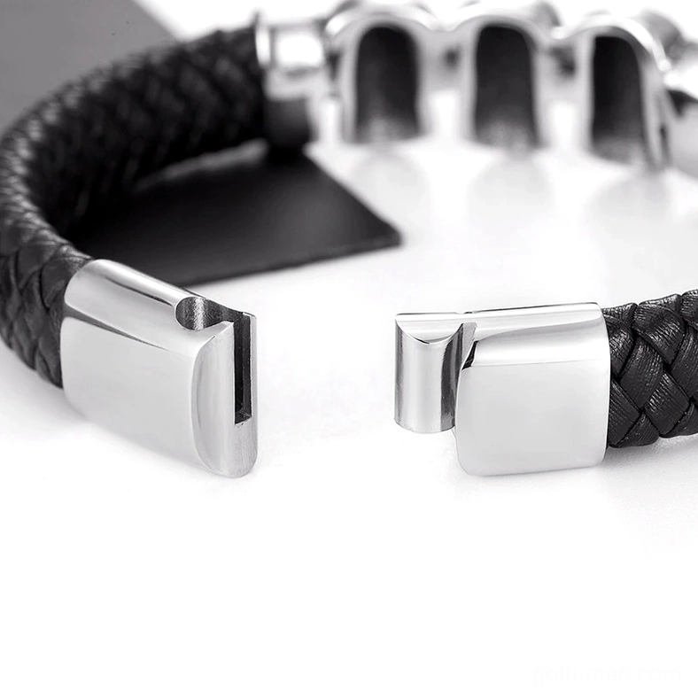 Close-up macro photograph of polished stainless steel magnetic snap closure on gothic leather bracelet