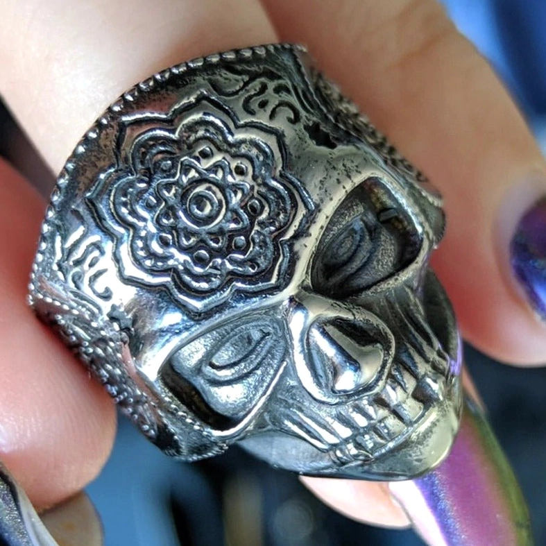 Gothic biker ring side view displaying large mandala engraved skull top and band filigree detail when worn