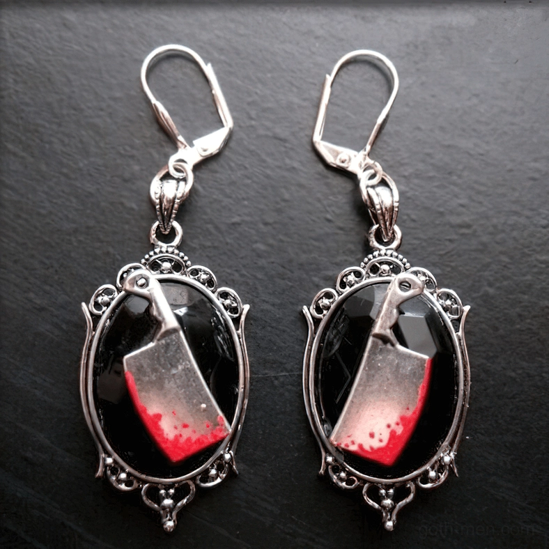 Gothic meat cleaver earrings with carved metal frame and lever-back ear hooks, dark grey background front view