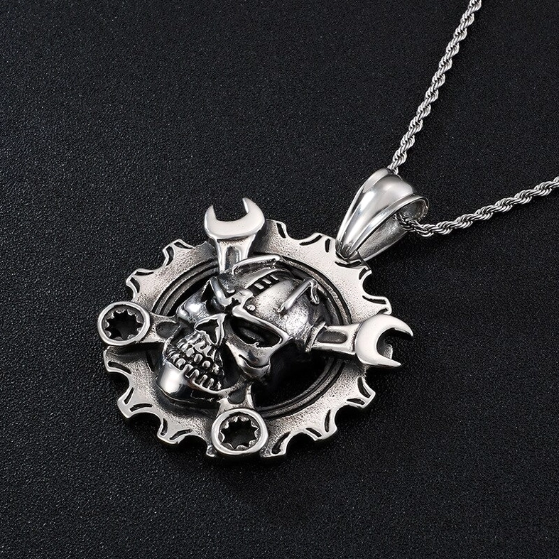 Overhead view of mechanical skull gear pendant and twisted chain showing clear gothic steampunk details