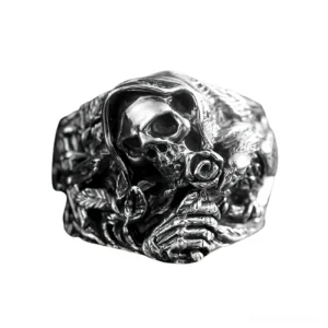 Gothic skeleton skull ring three-quarter angle showing carved hand and sword motifs in polished silver