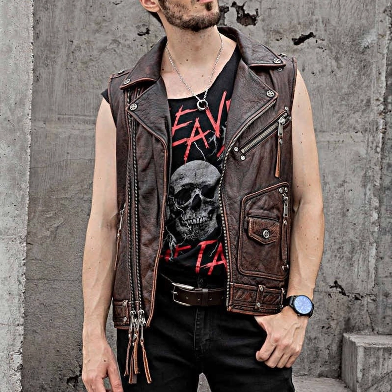 Male model wearing vintage brown leather gothic biker vest with industrial concrete background casual streetwear