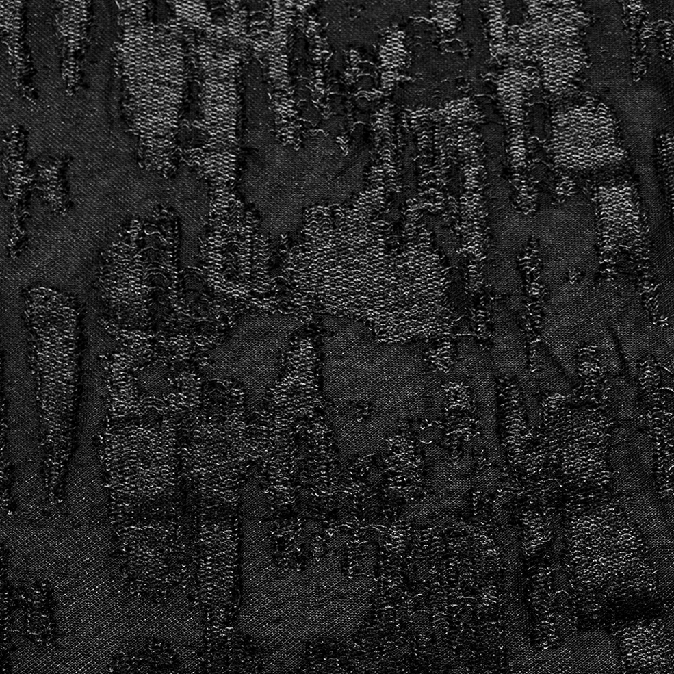 Men's black gothic tank top fabric texture close-up - cracked distressed weave and sheer material detail