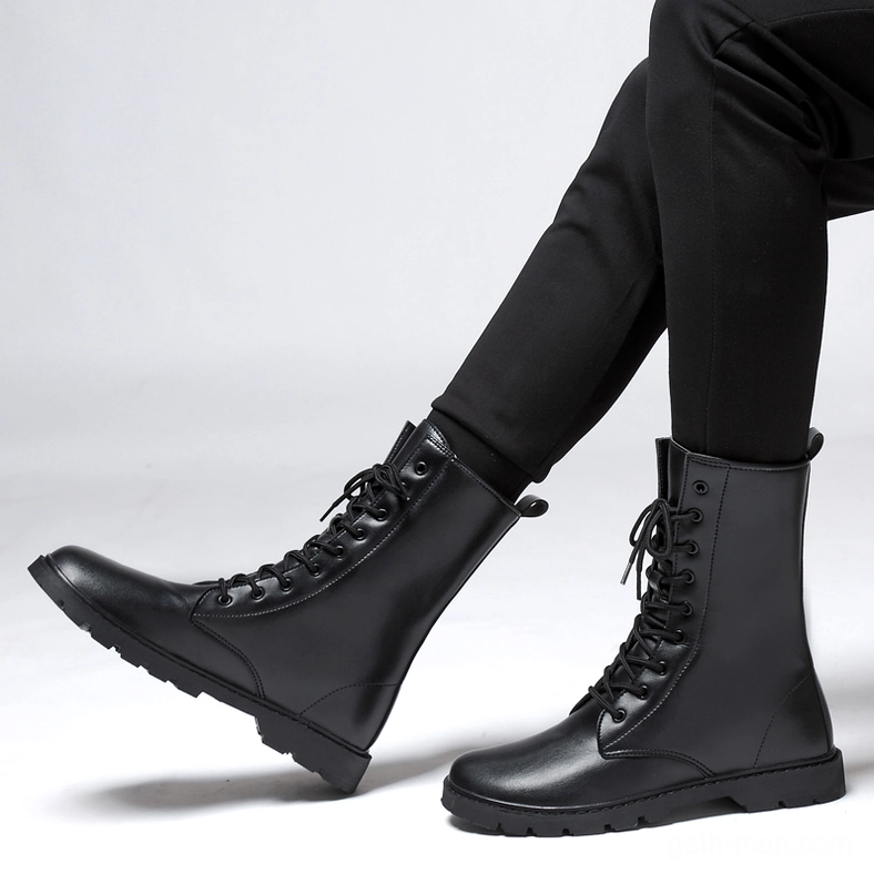 Wearer in crossed legs pose showing black gothic combat boots – men's high-top lace-up leather boots with durable rubber outsole