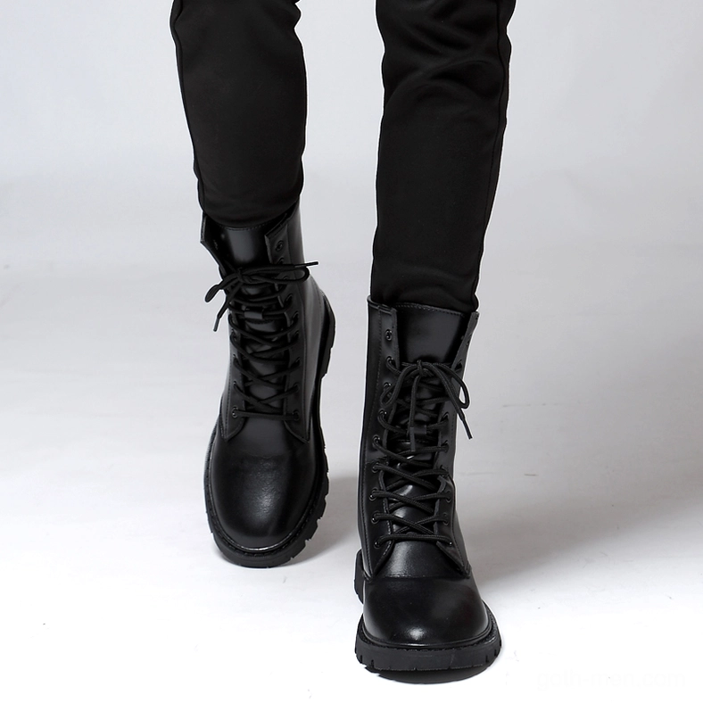 Man wearing black gothic combat boots – front low angle view with neatly tied laces