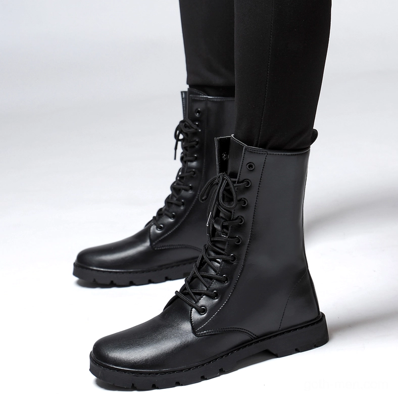Man wearing black gothic combat boots – high-top leather lace-up boots front three-quarter view