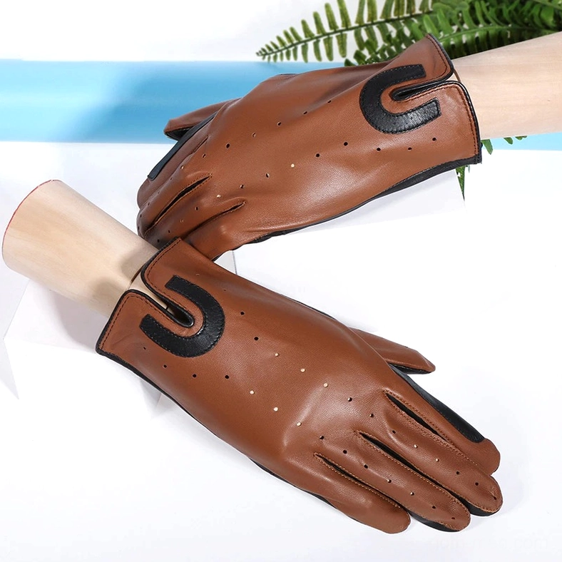 Brown sheepskin riding gloves displayed on mannequin hands with black decorative U-patches and perforated breathable holes, studio display