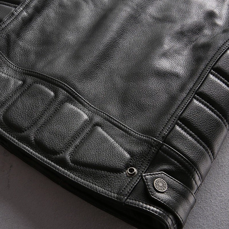 Full-length studio shot of model styled in gothic leather motorcycle biker vest