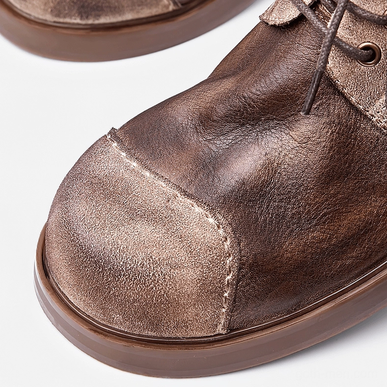 Men's dark distressed leather gothic boots lifestyle product shot, perfect for alternative fashion and goth aesthetic styling