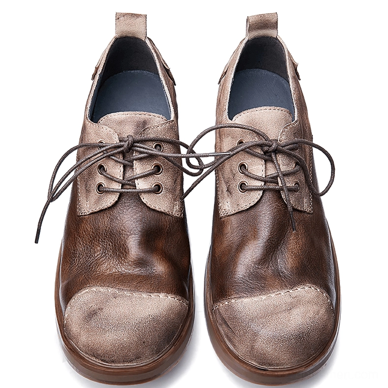Pair of men's dark leather gothic boots flat lay from above, showing distressed texture, blue inner lining, and lace-up closure detail