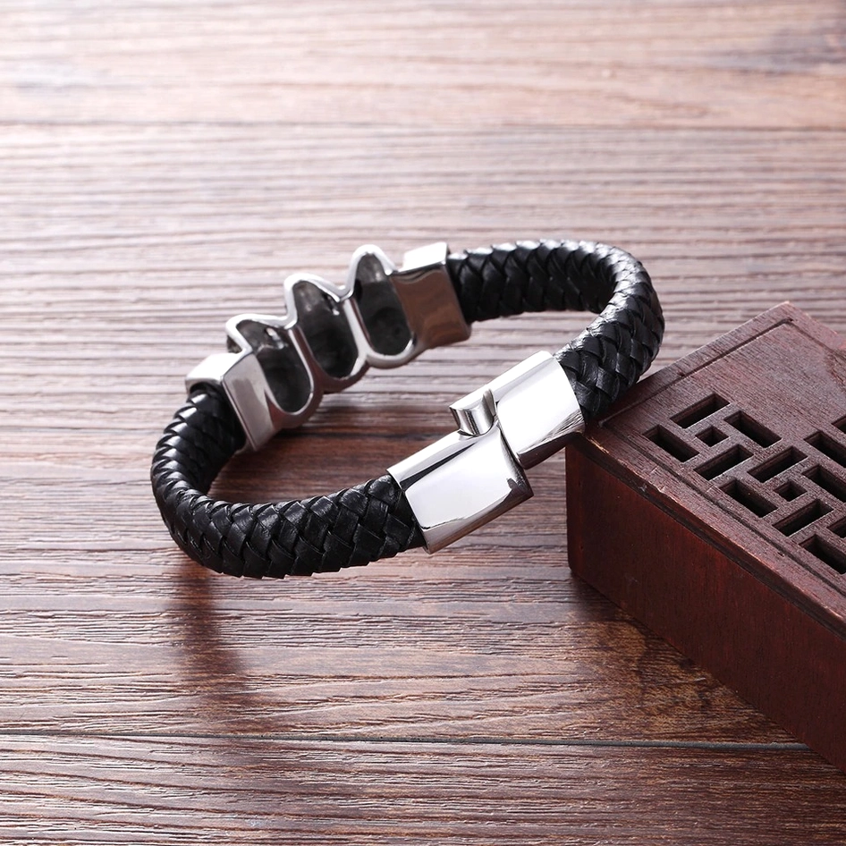 Black leather skull bracelet top-down side angle showing magnetic clasp mechanism and braided leather construction with decorative wooden setting