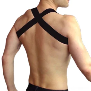 Black faux leather chest harness back view showing cross-back elastic shoulder straps and support structure on shirtless male model