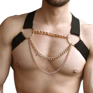Black men's chain chest harness with layered gold metal chains and rings on athletic male model, front close-up showing intricate chain detailing