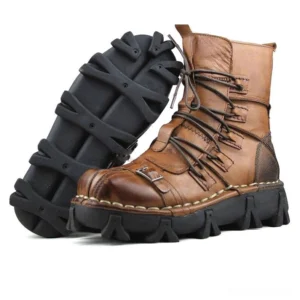 Distressed brown leather gothic rocker boots with contrast stitching and multiple lacing straps, side profile revealing rugged outsole and aged finish