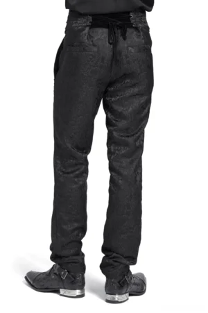 Men's gothic jacquard pants rear view - showing velvet corset back detail and tapered silhouette worn with leather shoes