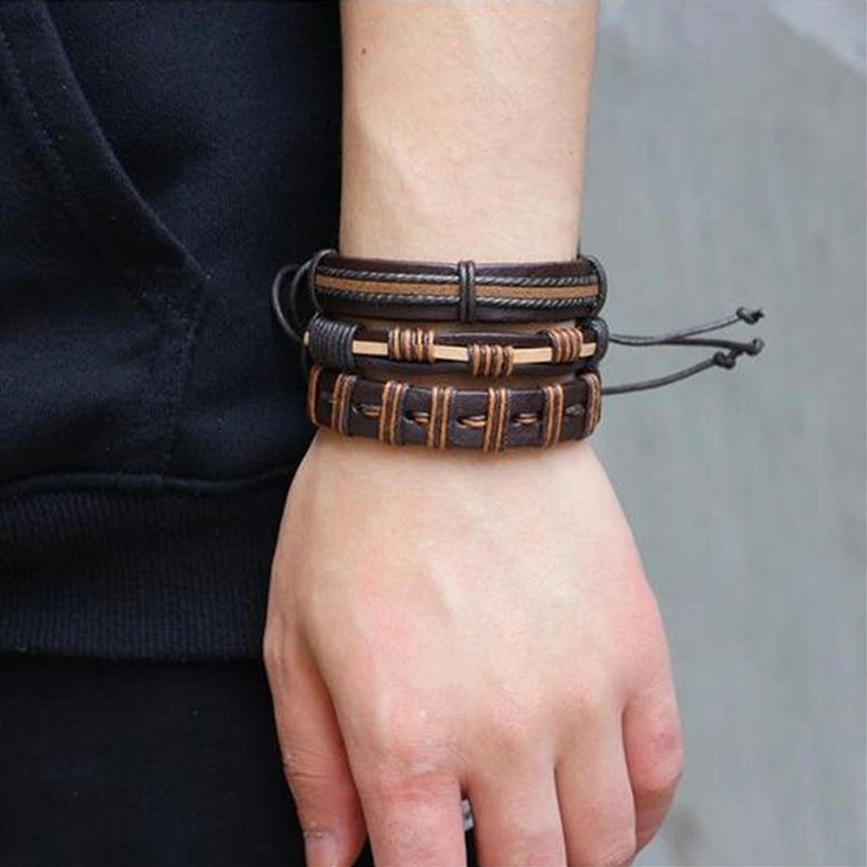 Male wrist wearing stacked gothic brown leather bracelets with adjustable pull cord and braided splice design side view