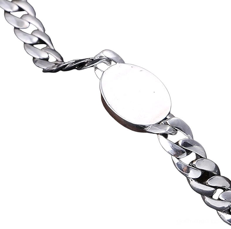Close-up side view of men's sterling silver gothic bracelet with smooth oval charm and detailed Cuban links