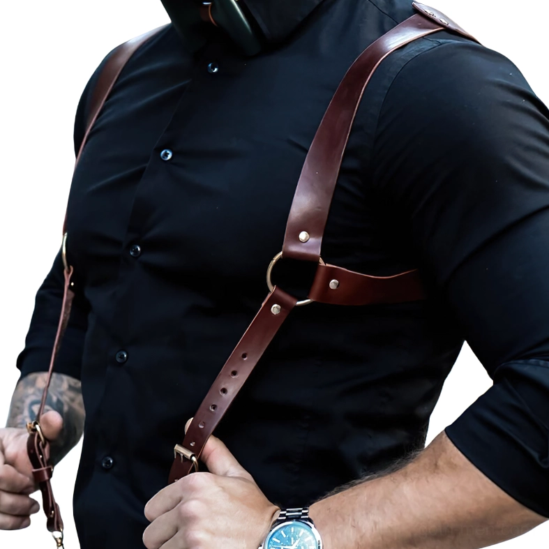 Brown leather chest harness for men with D-ring hardware - front close-up detail showing buckle construction