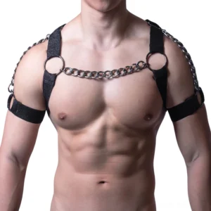 Men's black leather chest harness with metal chain straps and O-rings, front view on muscular male model, gothic body harness design