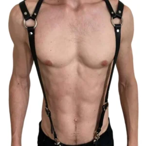 Black adjustable faux leather chest harness with shoulder straps and metal hardware, front view on shirtless male